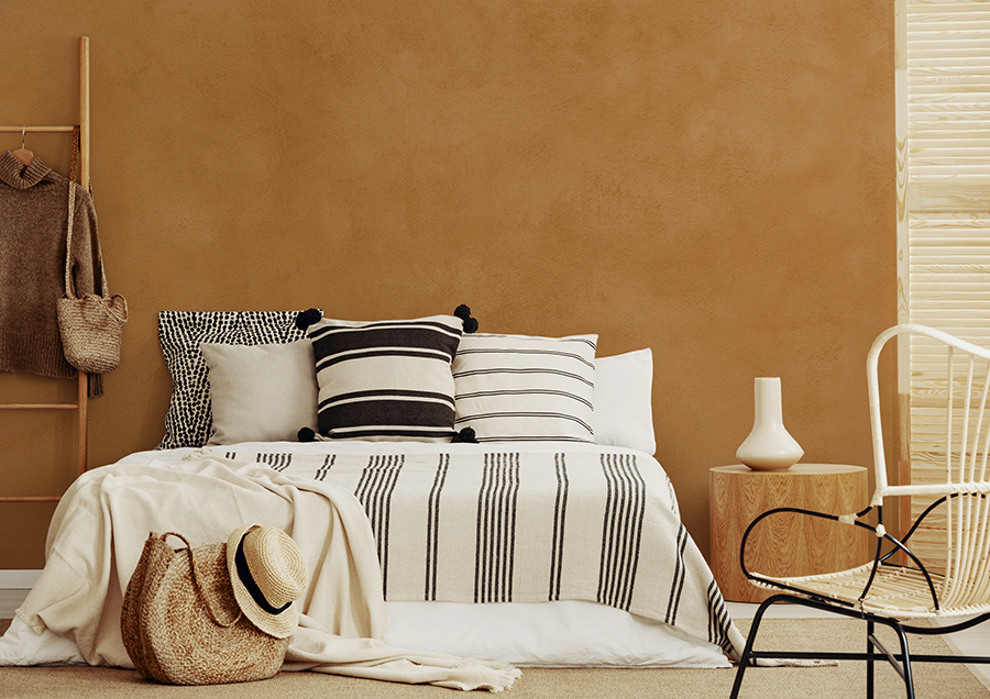 bedroom with wall clad in lime mortar