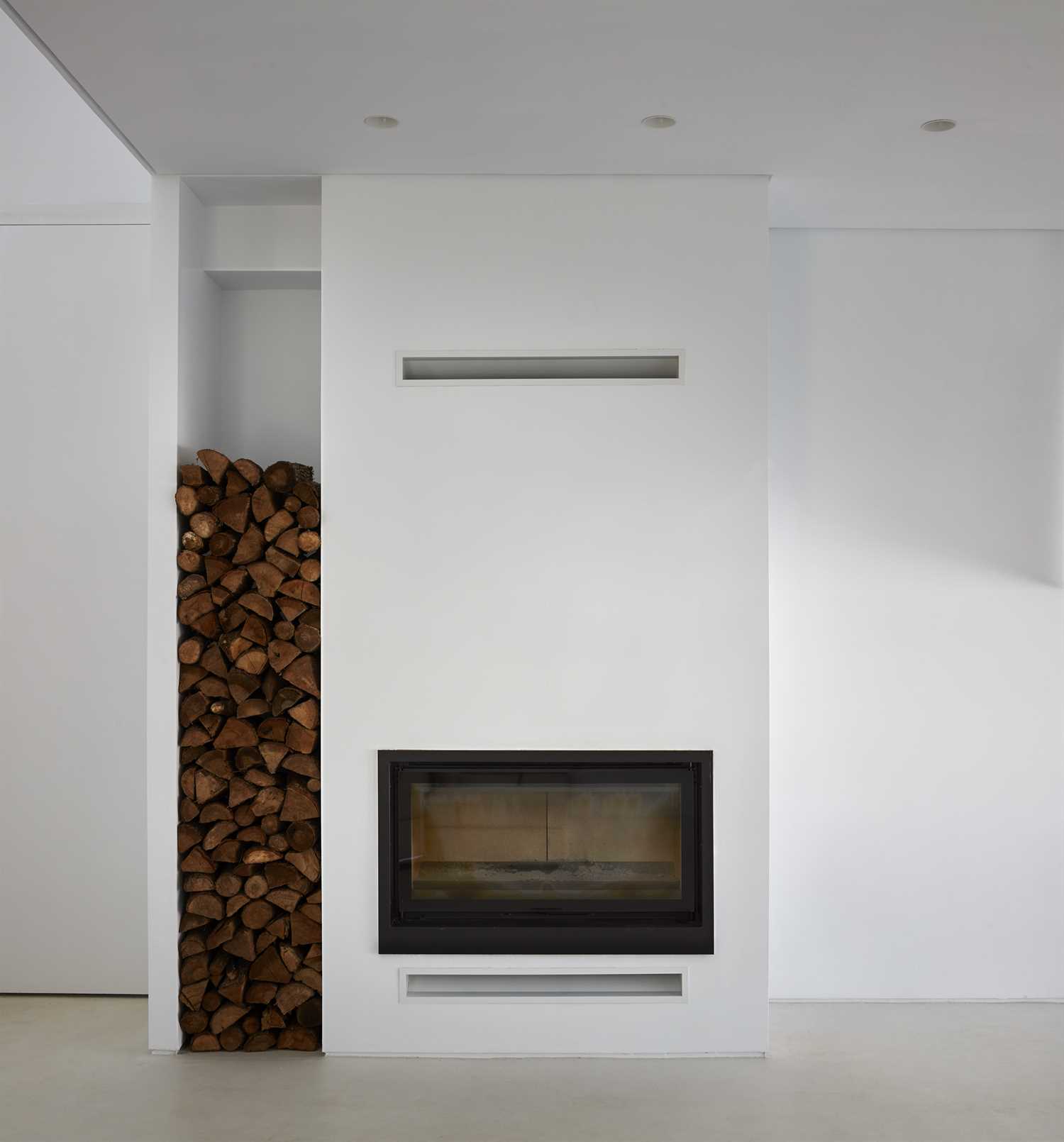 White microcement on walls and fireplace.