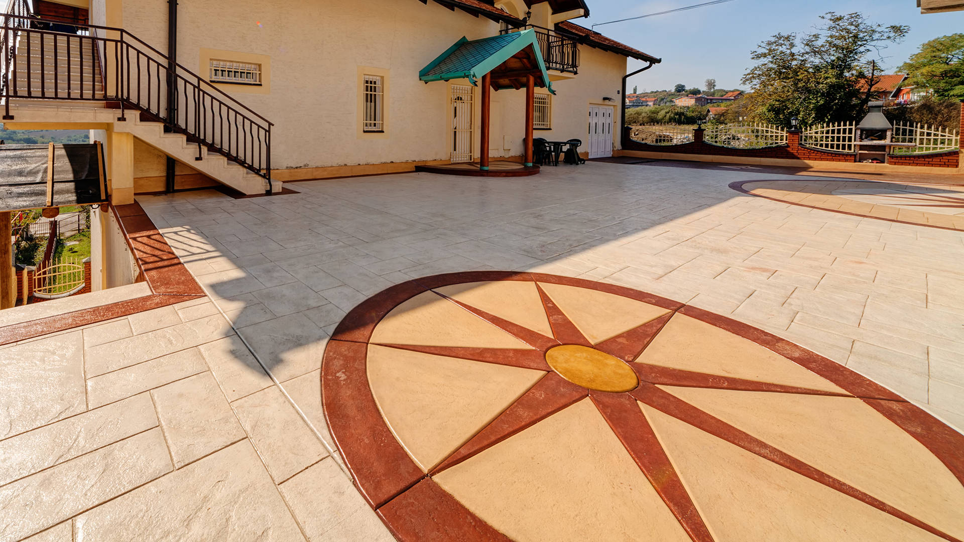 backyard terrace floor with imprinted pavement with compass rose mold