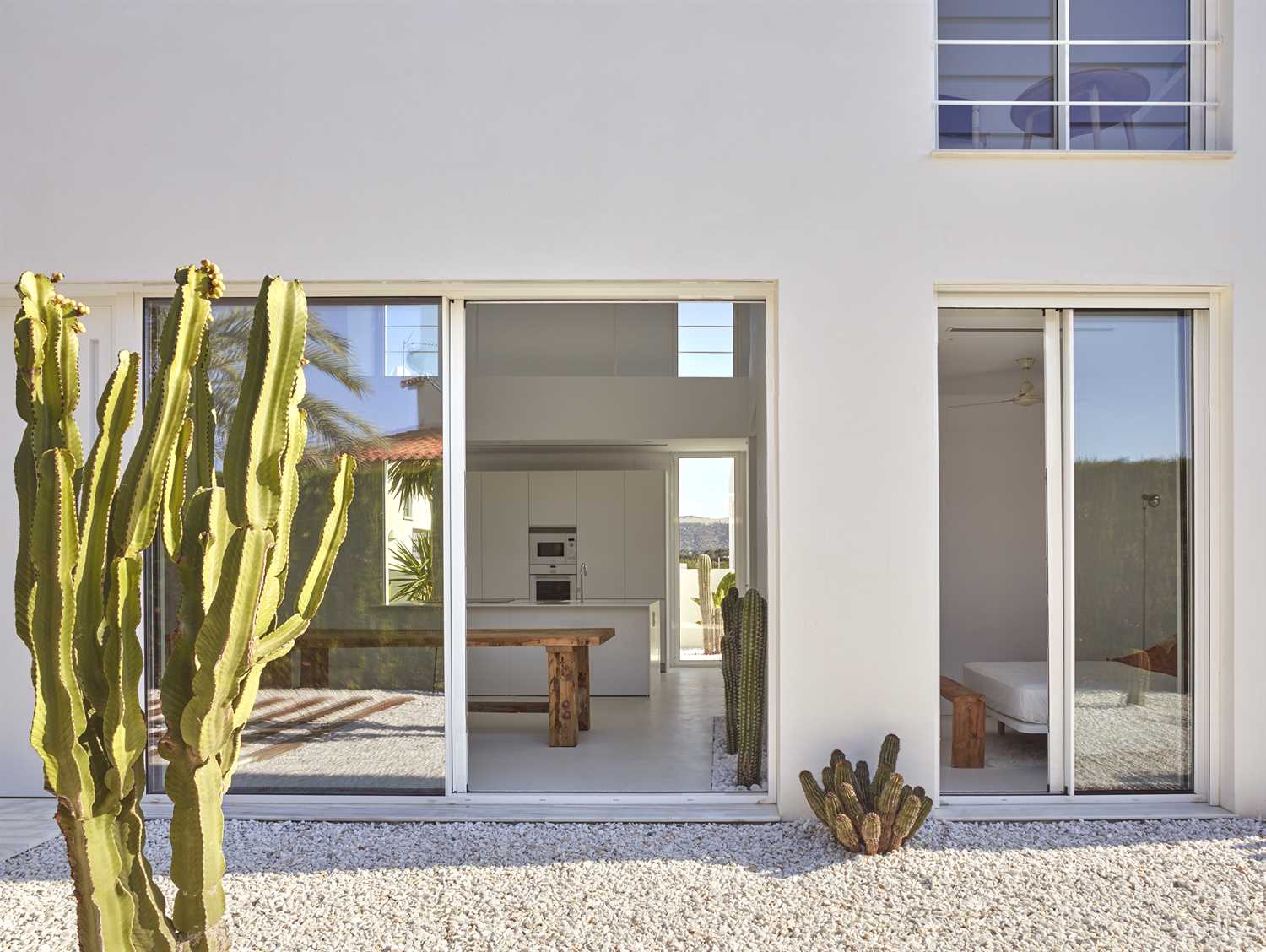 Interior and exterior walls of white microcement in renovated house.