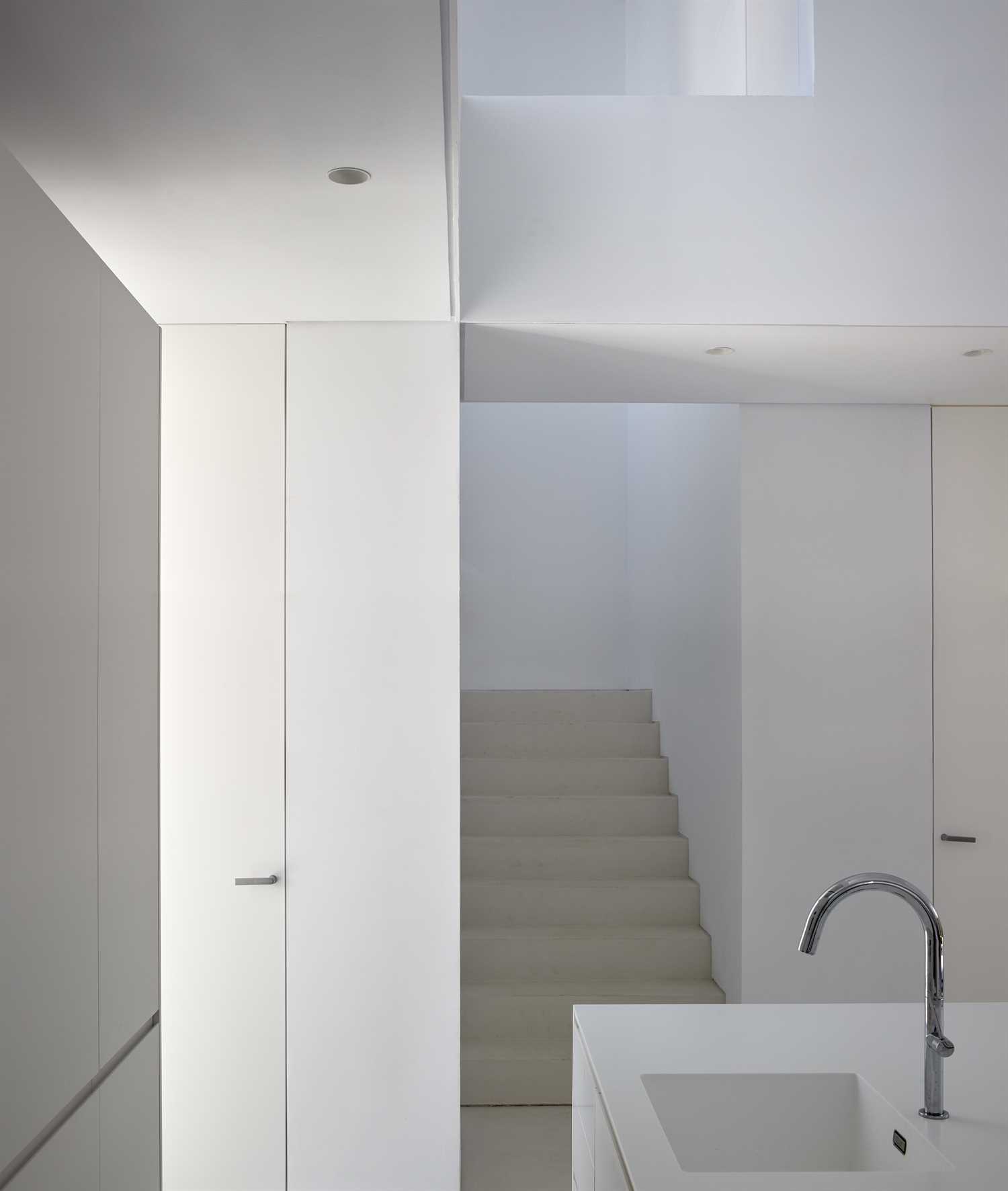 White microcement on floor, walls and ceiling of renovated house.