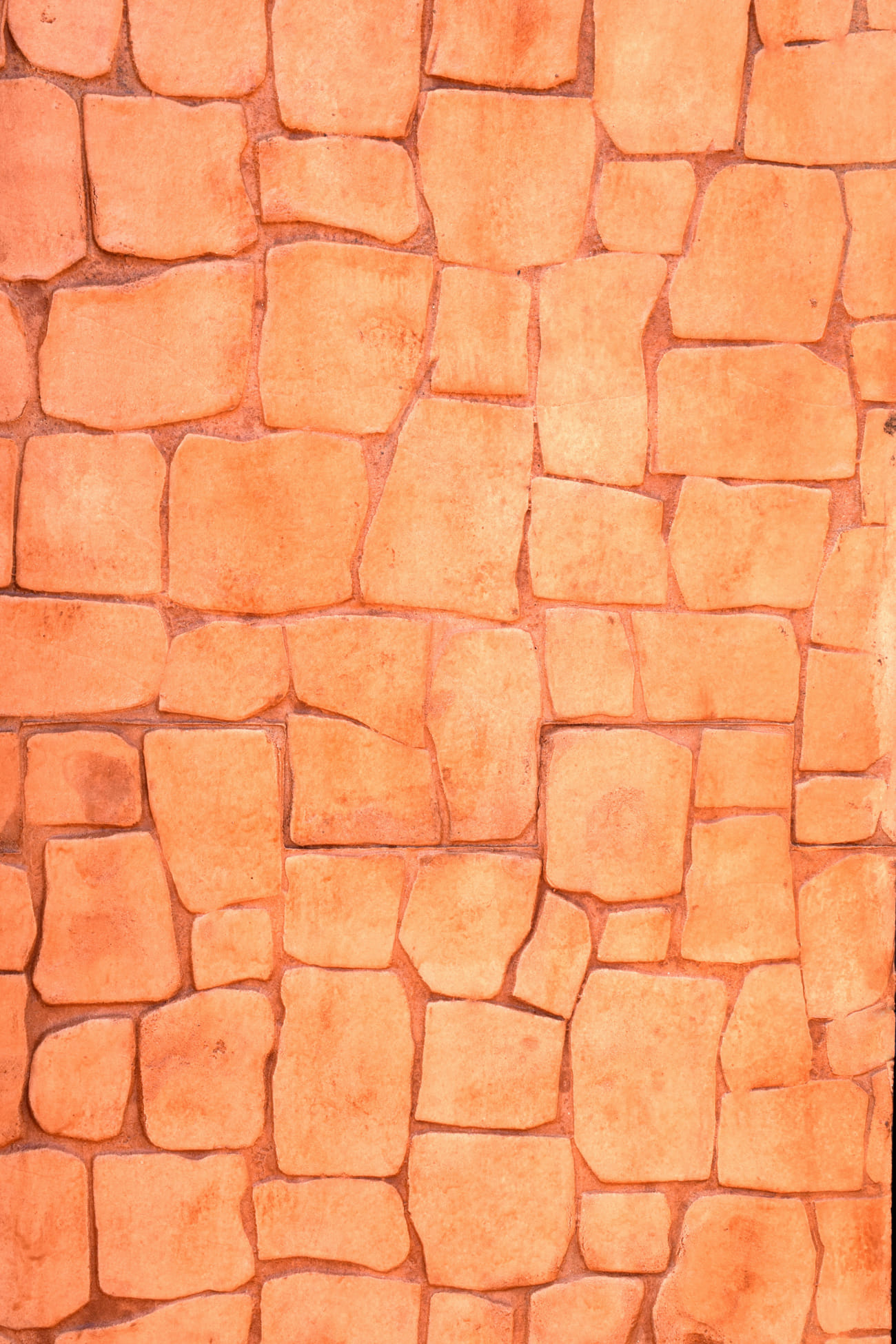 Vertical imprinted concrete with orange-colored stone effect