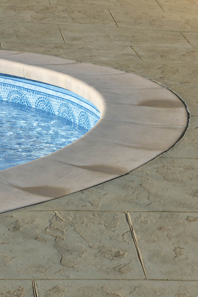stamped concrete floor in swimming pool area 
