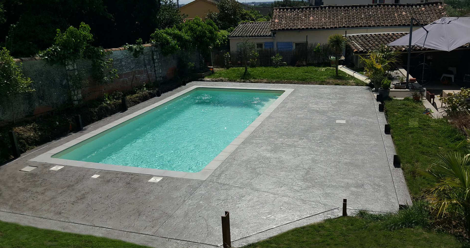   grey stamped concrete swimming pool