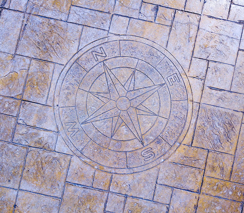  oxidised stamped concrete floor with compass rose